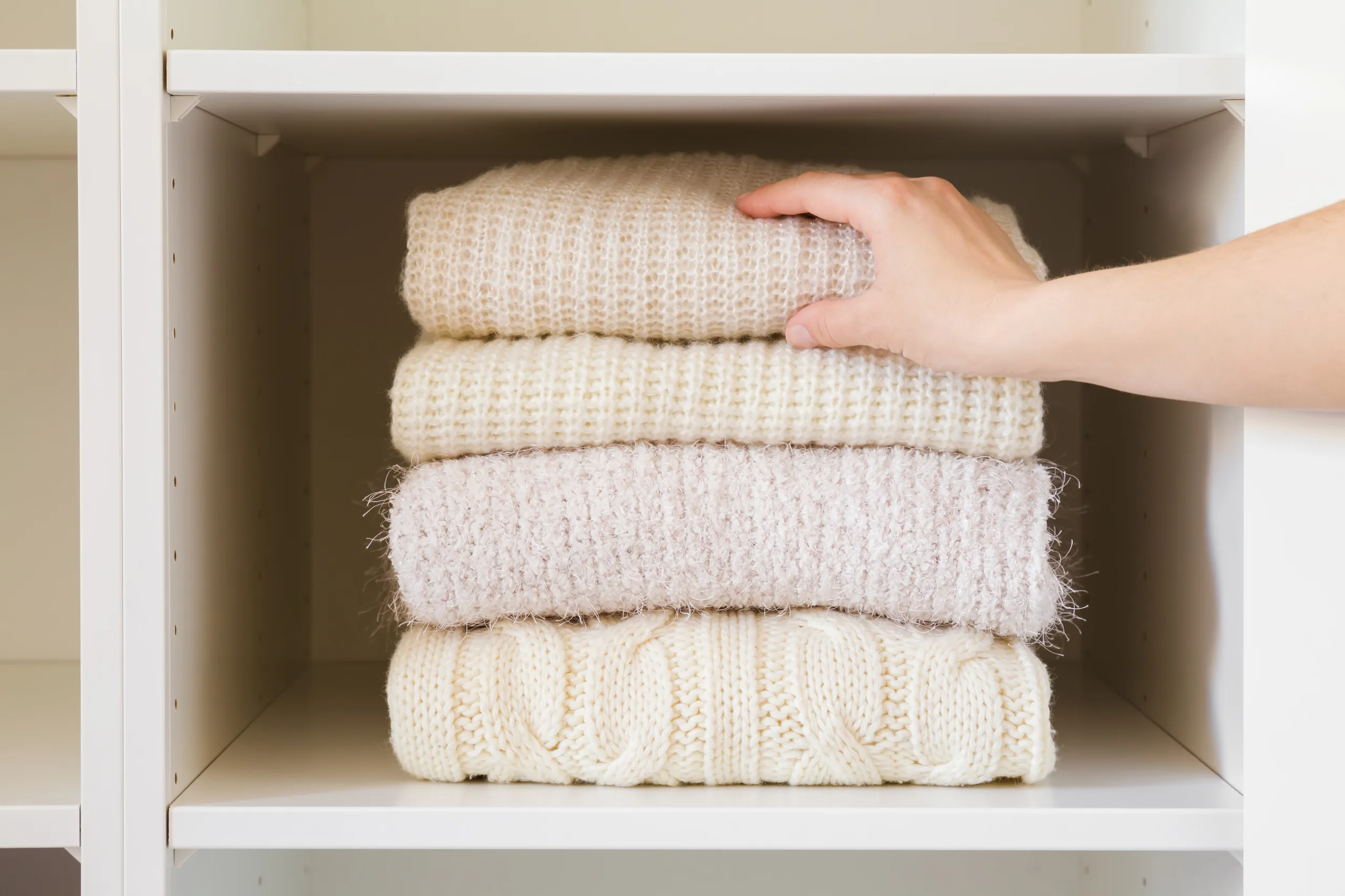 Folded sweaters in storage